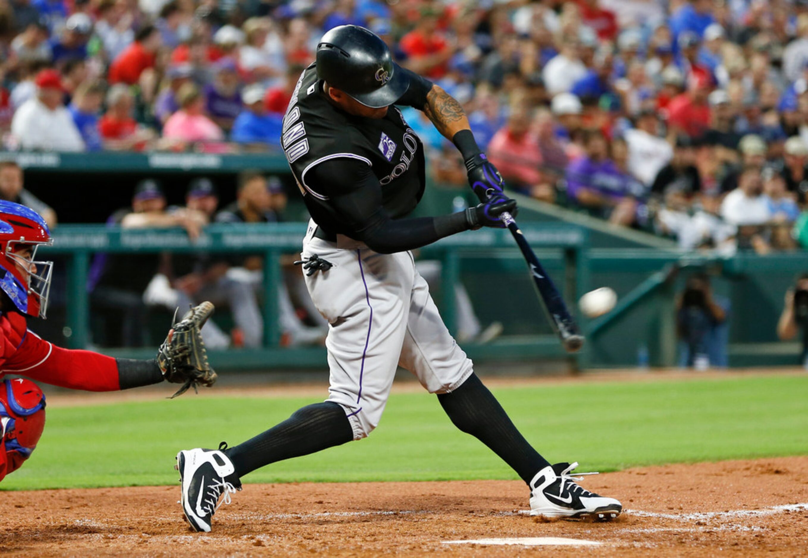 Colorado Rockies' Ian Desmond connects for a home run off Texas Rangers starting pitcher...