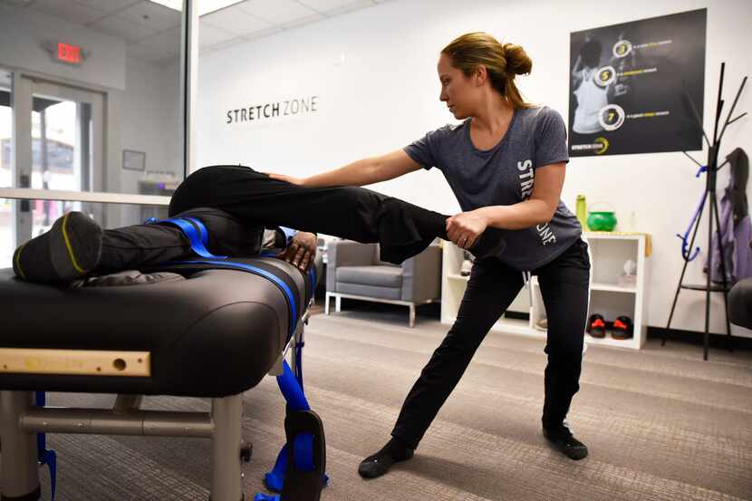 Stretch practitioner Danielle D'Alesio works on client Sergeant Jeff Wilson, of the Dallas...