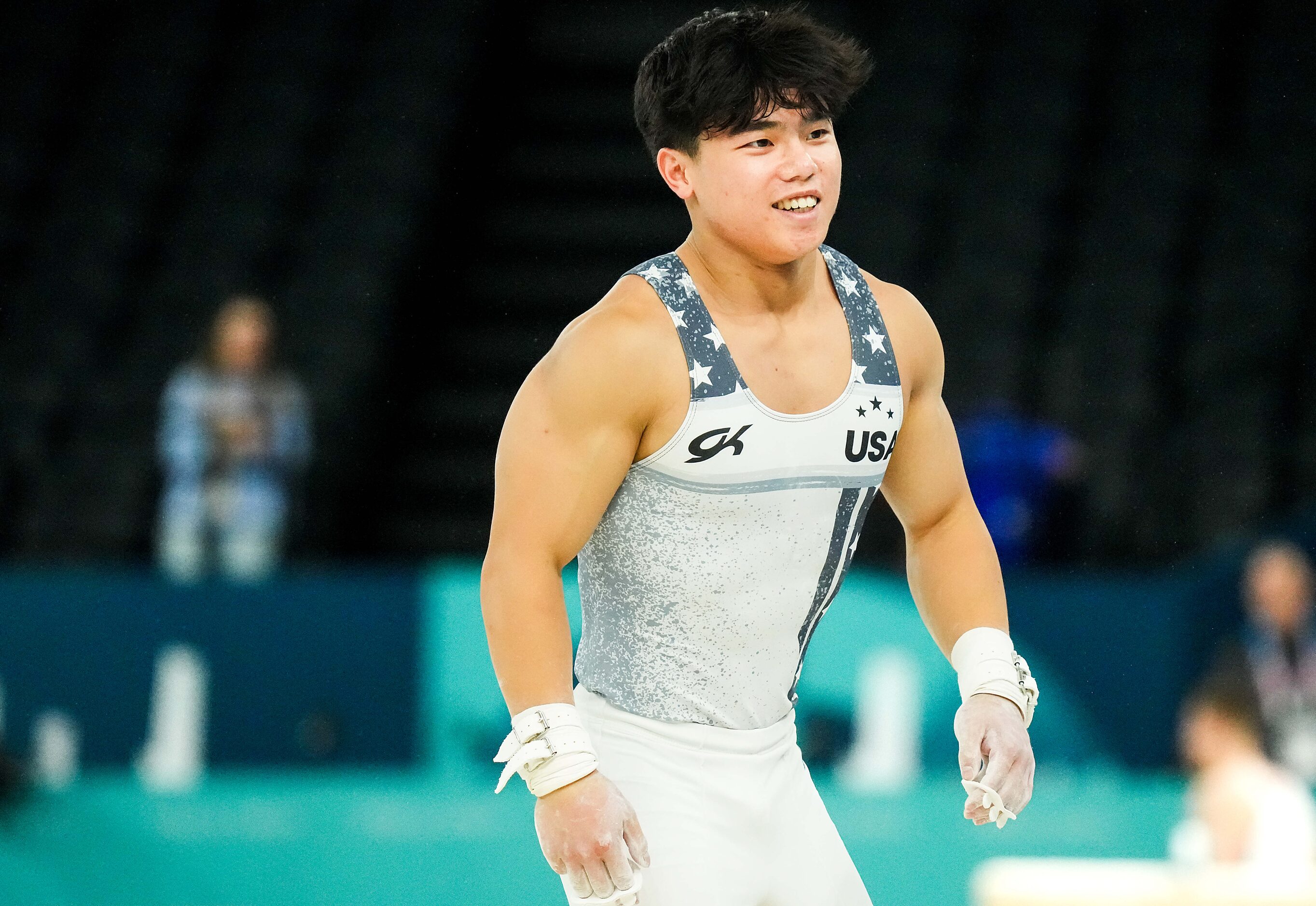 Asher Hong of the United States reacts after a turn on the high bar during gymnastics podium...