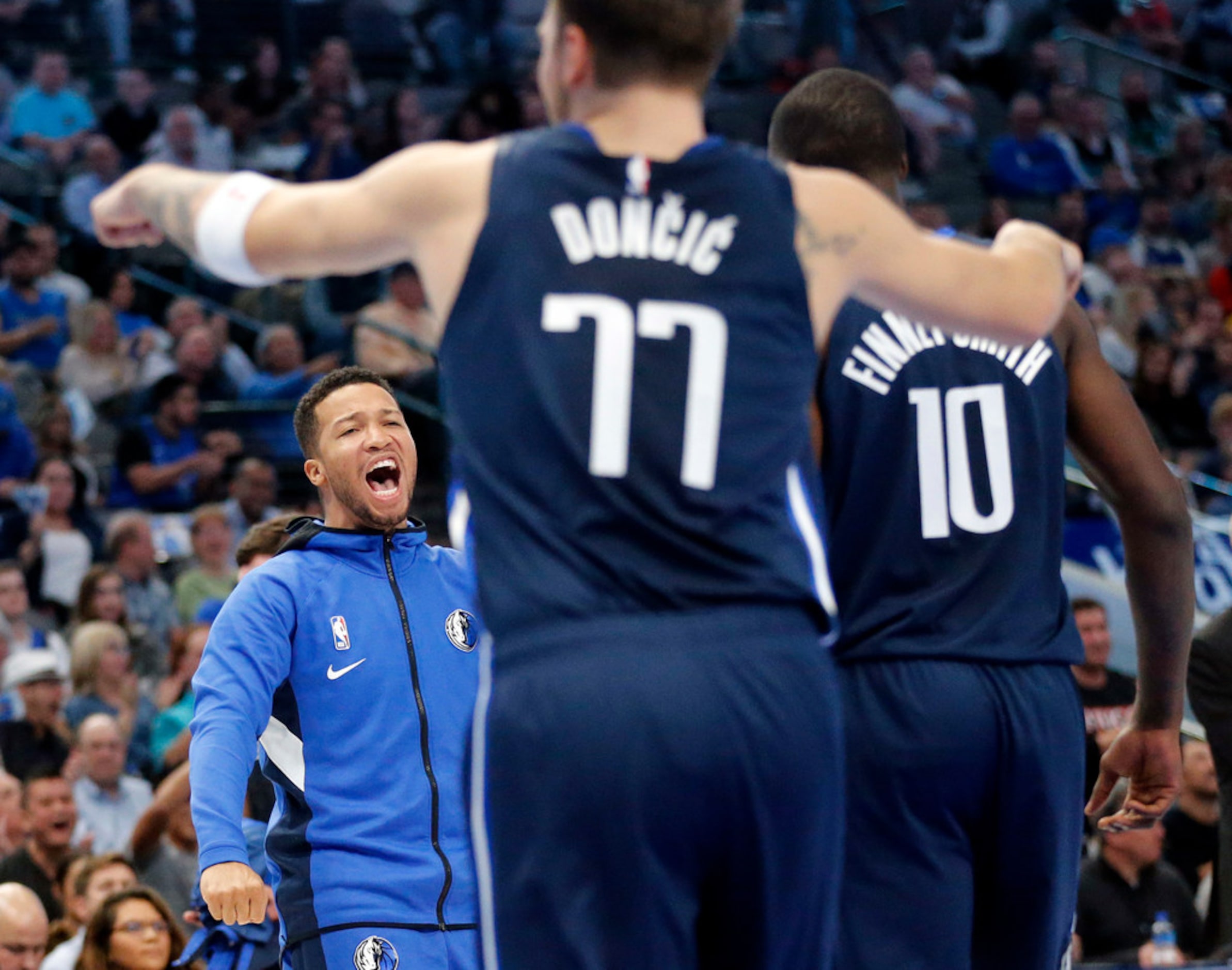 Dallas Mavericks guard Jalen Brunson (left) celebrates Dorian Finney-Smith's (10) dunk after...