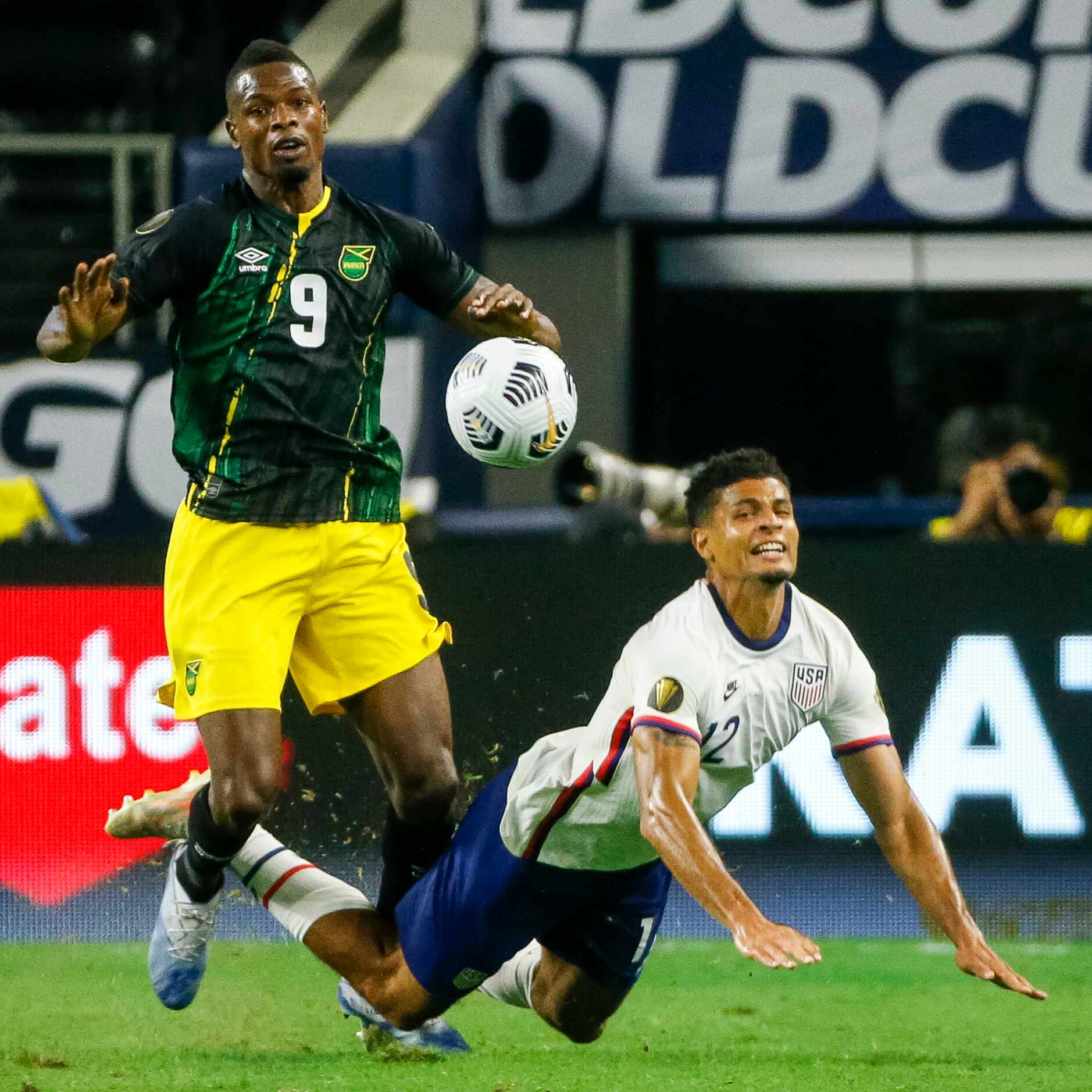 USA defender Miles Robinson (12) falls to the ground in front of Jamaica forward Cory Burke...