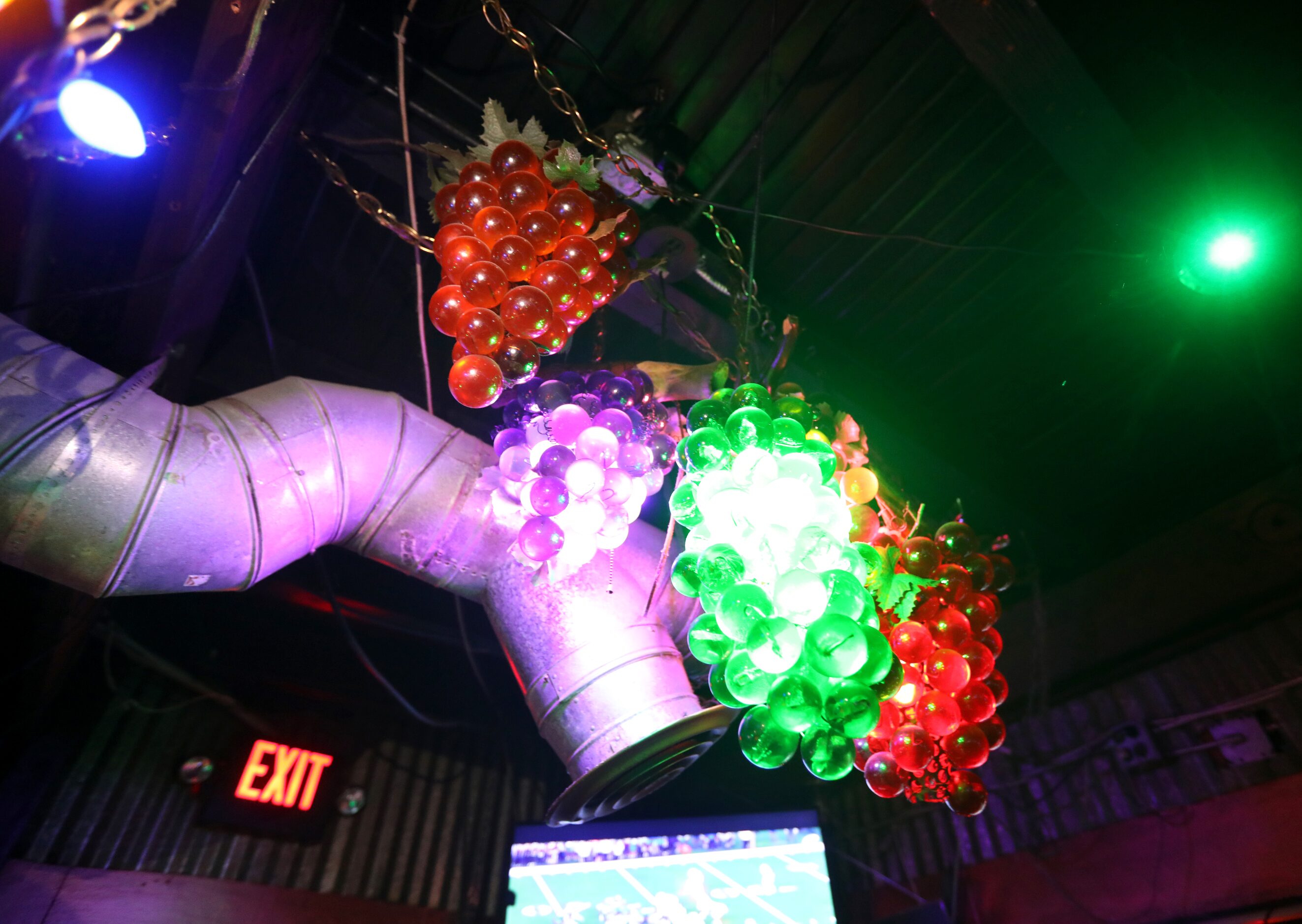 The "dive bar" theme can be seen from the ceilings to the floors with grape-themed...