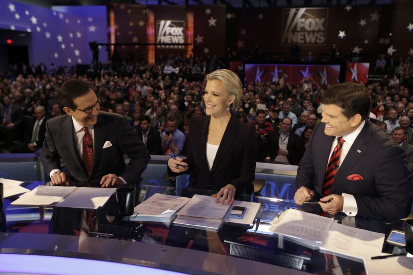 Moderators Chris Wallace, Megyn Kelly and Bret Baier smile as they wait for a Republican...