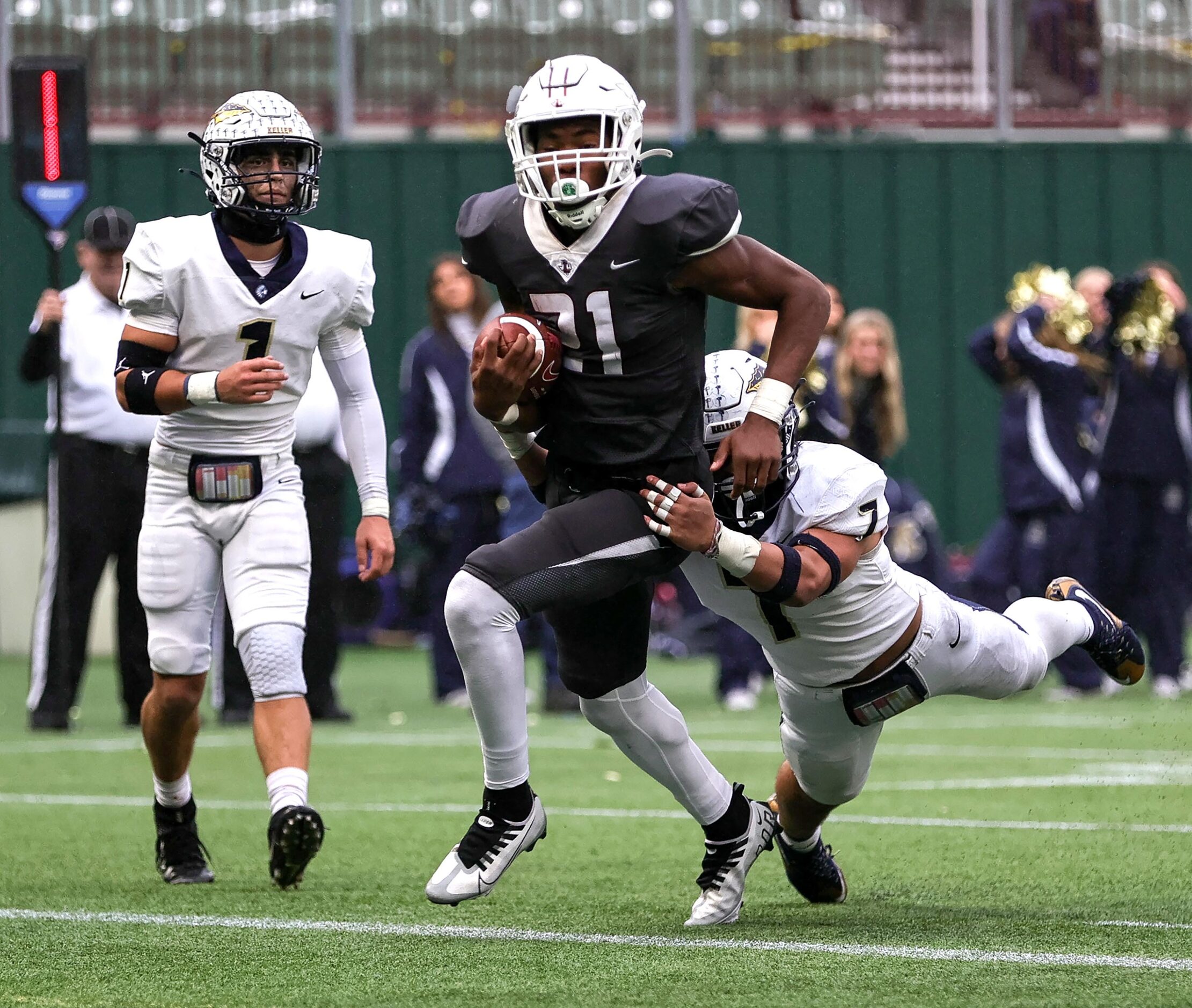 Lewisville running back Viron Ellison (21) fights his way into the end zone for a touchdown...