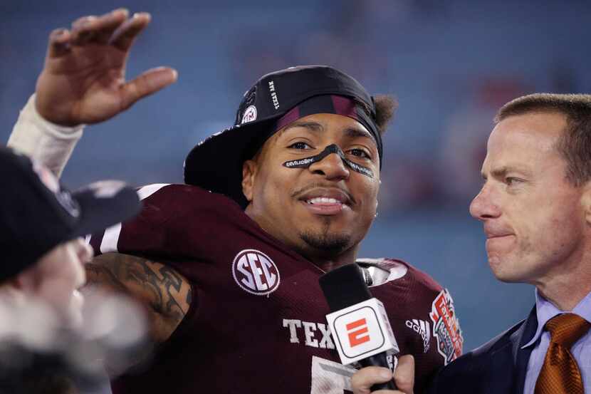 JACKSONVILLE, FL - DECEMBER 31: Trayveon Williams #5 of the Texas A&M Aggies salutes fans...