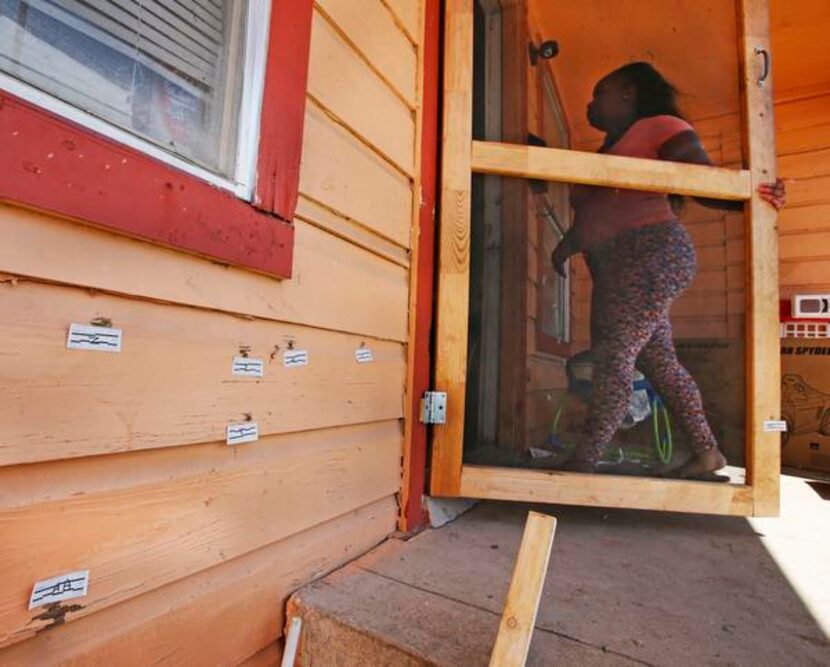 
Bullet holes riddle the siding of the house at the scene of the murder of Rubin Brown in...