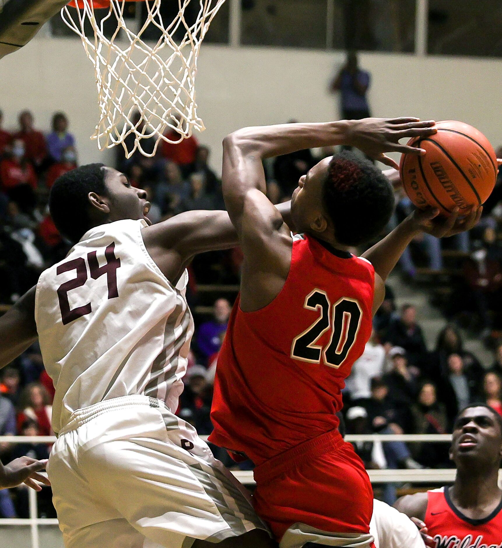 Lake Highland guard Tre Johnson (20) tries to get a shot off against Plano forward Robert...