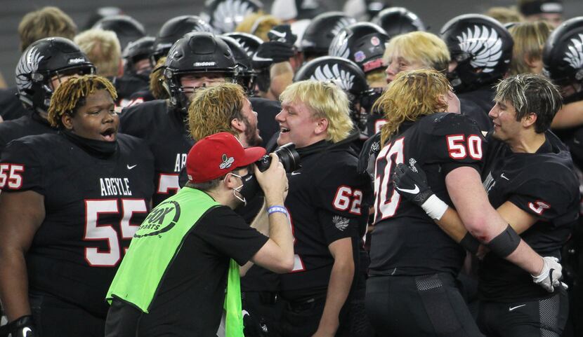 Argyle players celebrate their 49-21 victory over Lindale to claim the state title and...