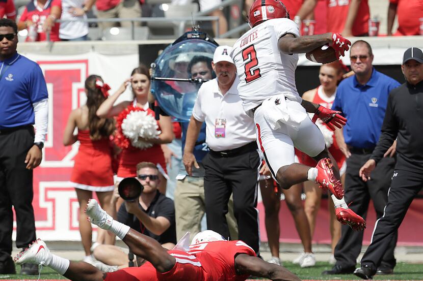 HOUSTON, TX - SEPTEMBER 23: Keke Coutee #2 of the Texas Tech Red Raiders is tripped by...