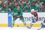 Dallas Stars center Sam Steel (left) follows as he passes the puck past Colorado Avalanche...