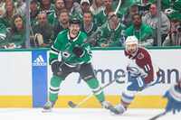 Dallas Stars center Sam Steel (left) follows as he passes the puck past Colorado Avalanche...