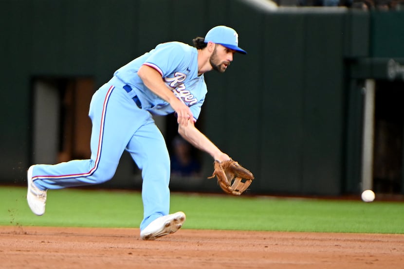 Texas Rangers shortstop Charlie Culberson (2) makes a play on a ground ball in the second...