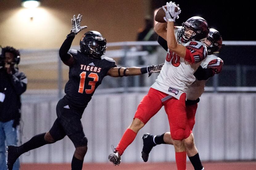 Mansfield Legacy junior wide receiver Payton Cathey (30) comes down with a touchdown...