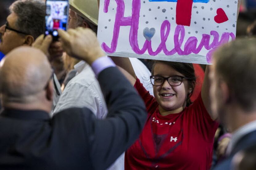 A supporter holds up a sign before Democratic presidential candidate Hillary Clinton at...