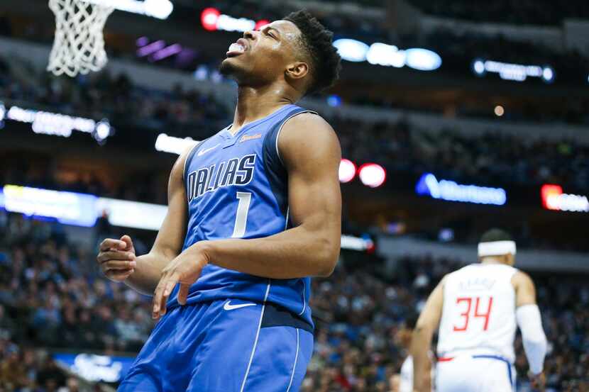 Dallas Mavericks guard Dennis Smith Jr. (1) reacts after Luka Doncic failed to catch his...