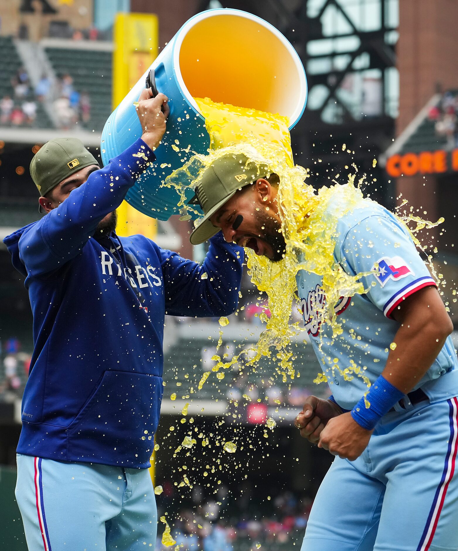 Texas Rangers center fielder Leody Taveras is dunked by starting pitcher Martin Perez after...