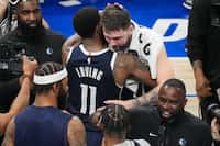 Dallas Mavericks guard Luka Doncic hugs guard Kyrie Irving after the Mavericks 108-105...