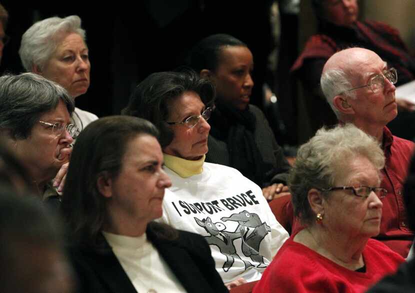 Nell Helfenbein (center) wore a white T-shirt with the words "I support Bruce" and spoke on...