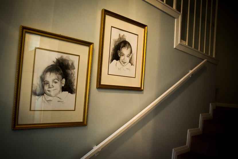 Baby images of Kara Zartler and her twin sister, Keeley, hang in the stairwell of the family...