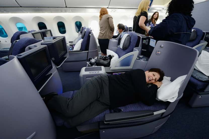 United Airlines sales manager Marilyn Jablonsky tries the new reclining Business First class...