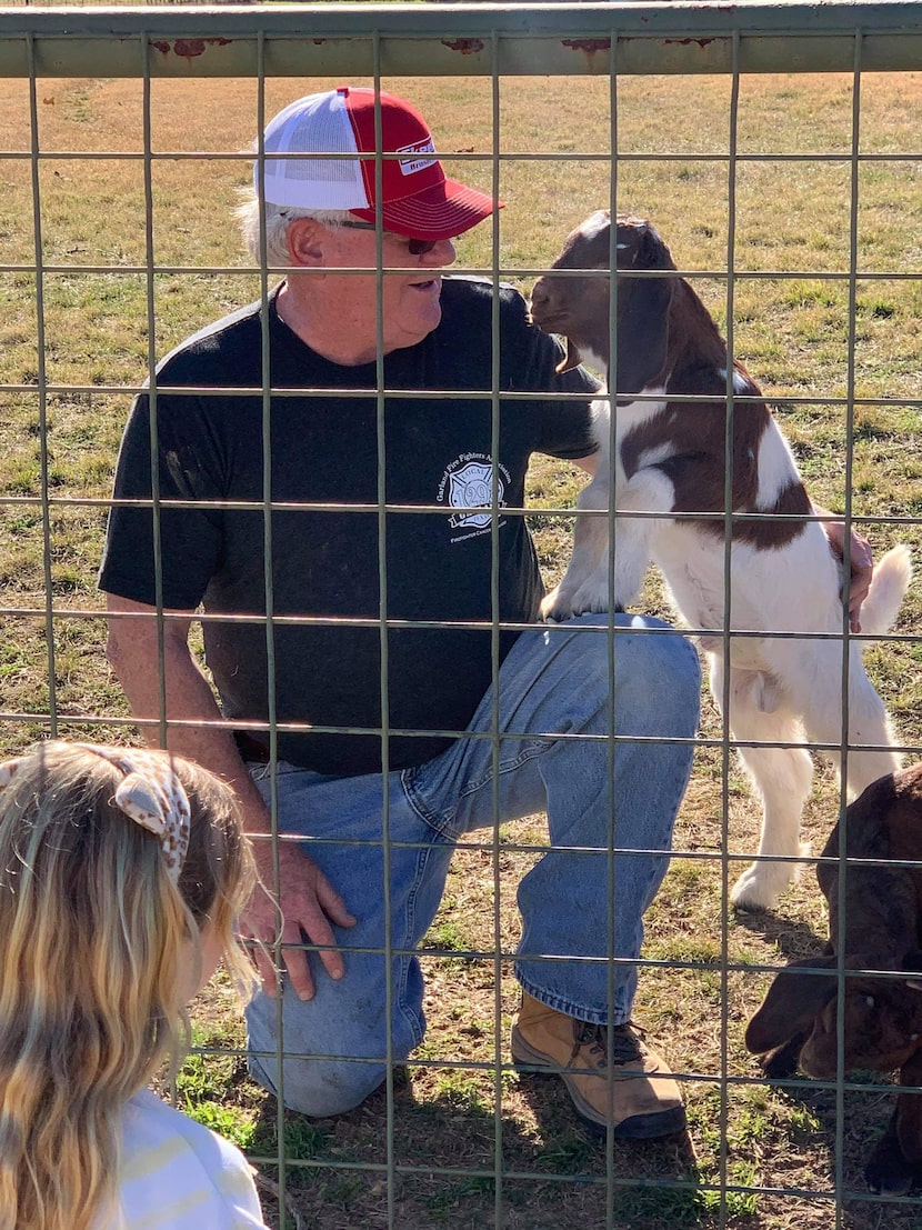 Current owner of Todd Goat Farm Mike Baker speaks with a visitor at the land’s fence line.