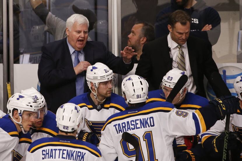 St. Louis Blues head coach Ken Hitchcock talks to his team during a time out during the...
