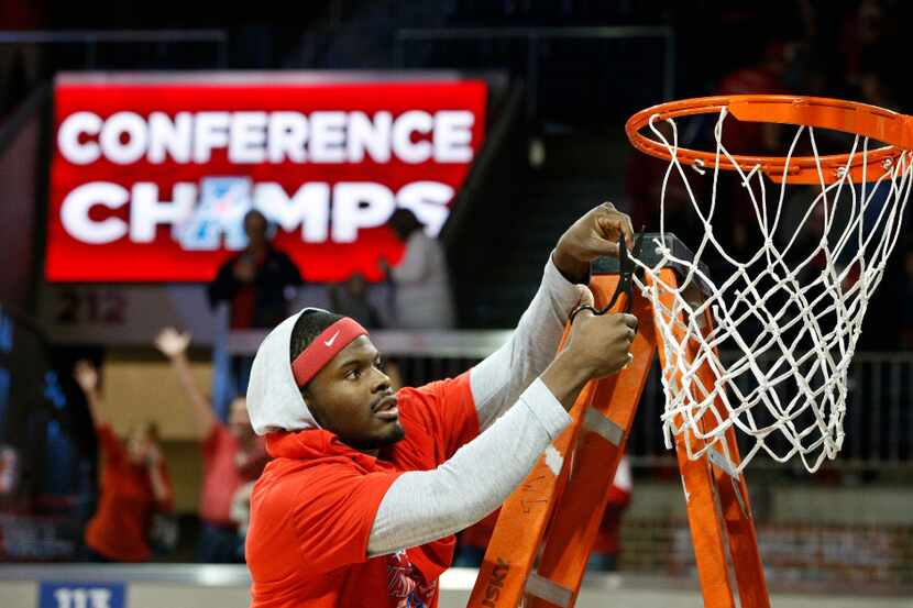 SMU guard Ben Emelogu (21) cuts the net after the Mustangs won the American Athletic...