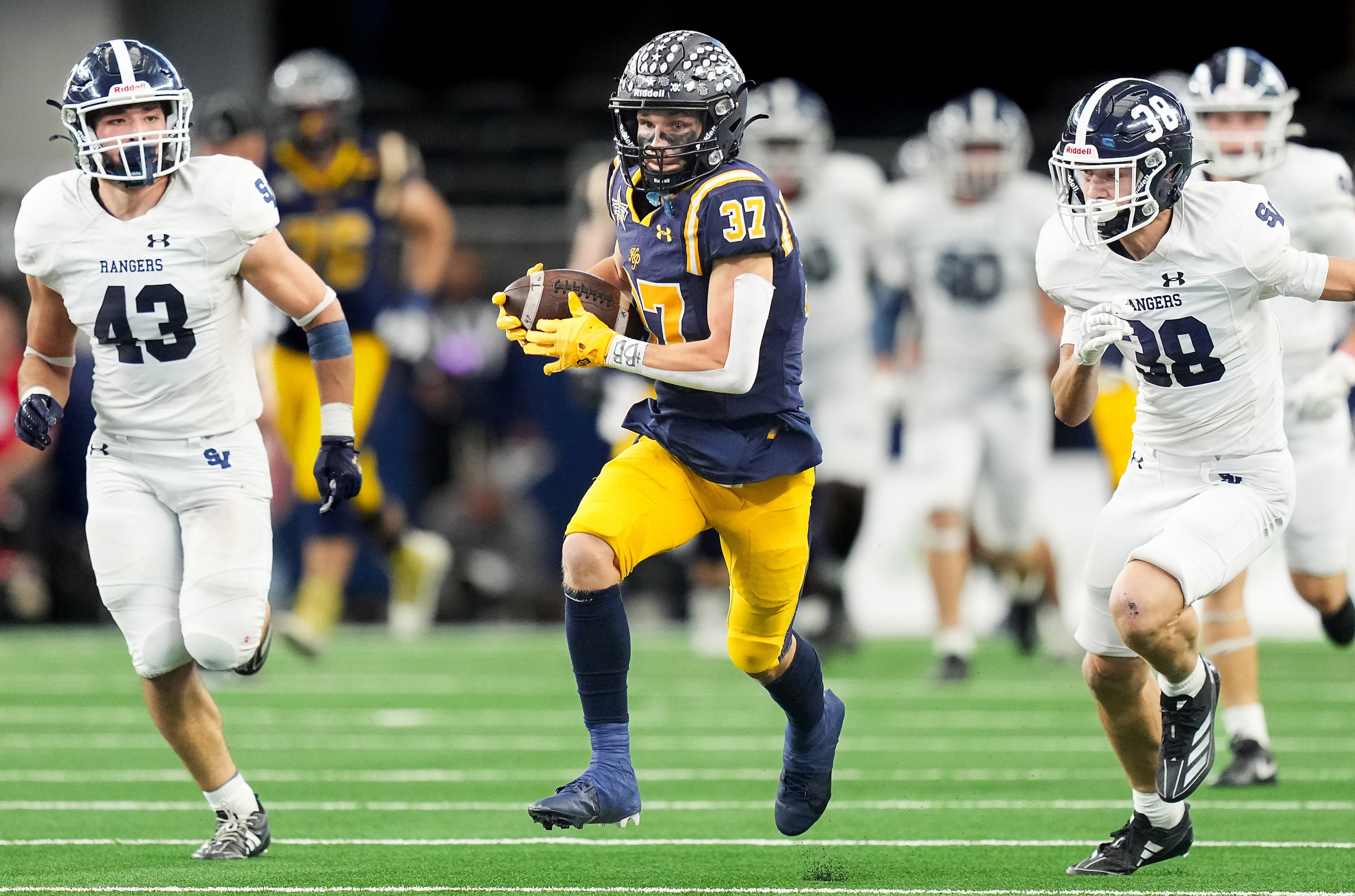 Highland Park's Cannon Bozman (37) gets past Smithson Valley's Diego Davila (43) and Hunter...