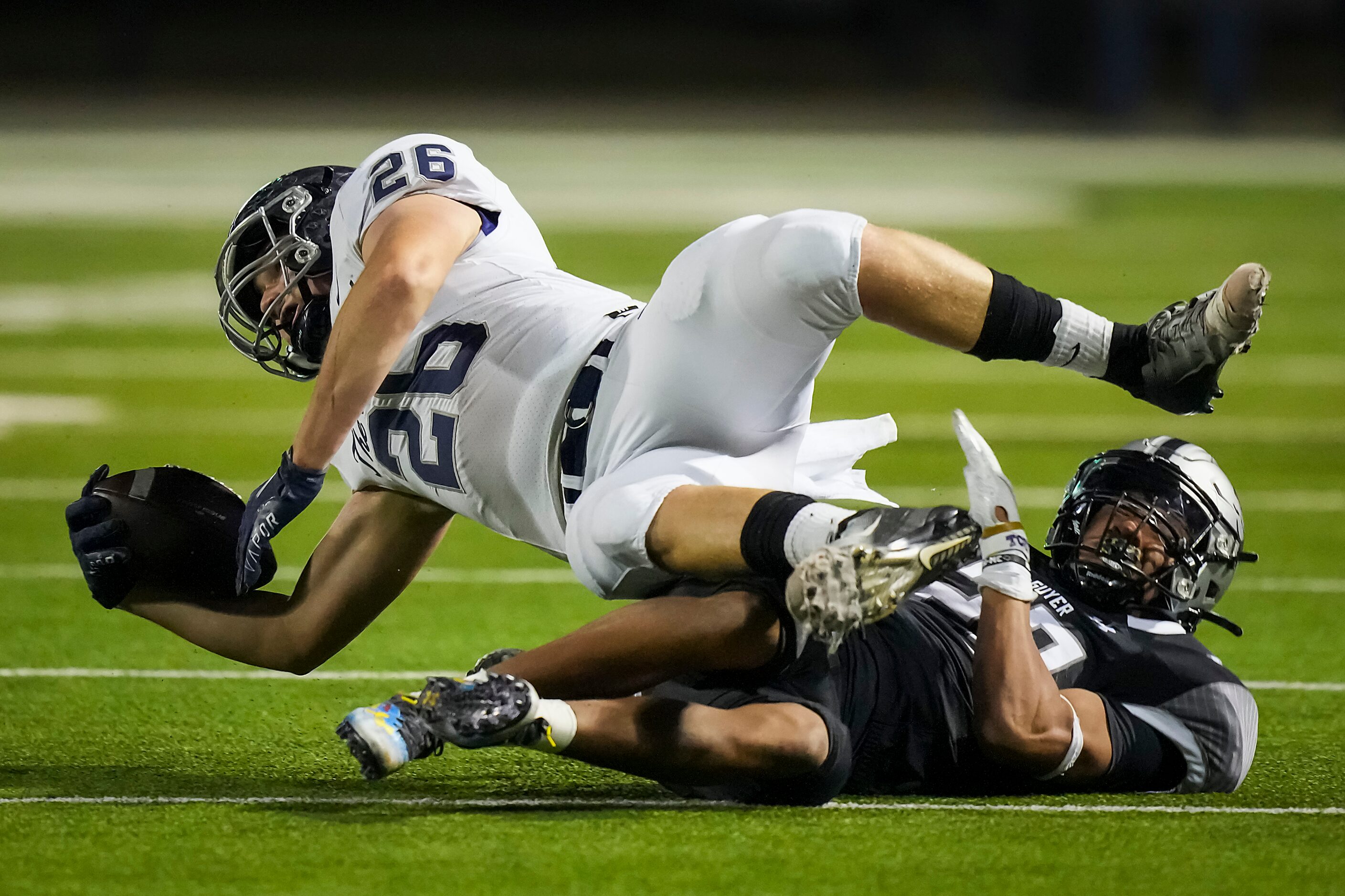 Flower Mound wide receiver Caden Jensen (26) is brought down by Denton Guyer defensive back...