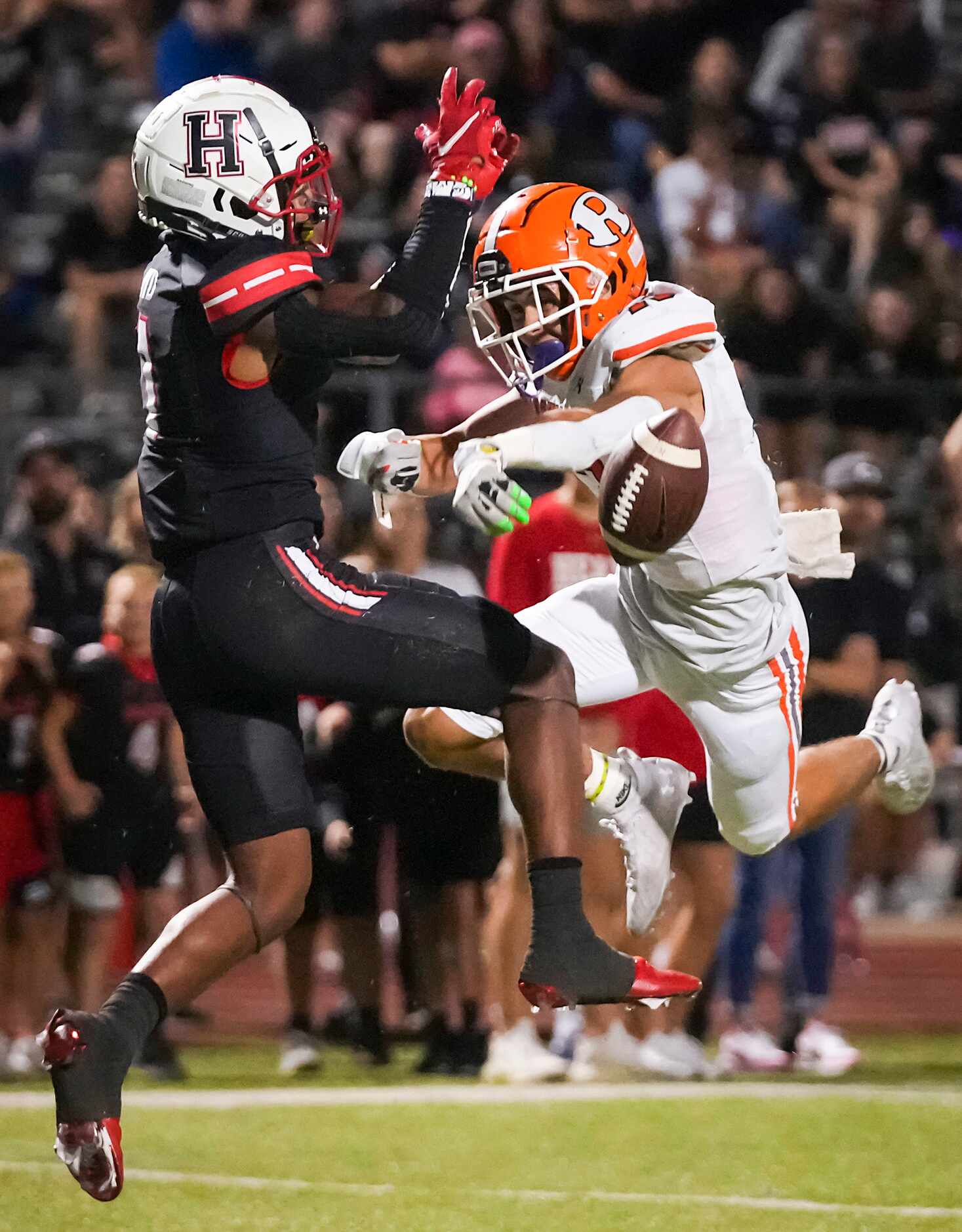 Rockwall defensive back Cadien Robinson (13) breaks up a pass intended for Rockwall-Heath...