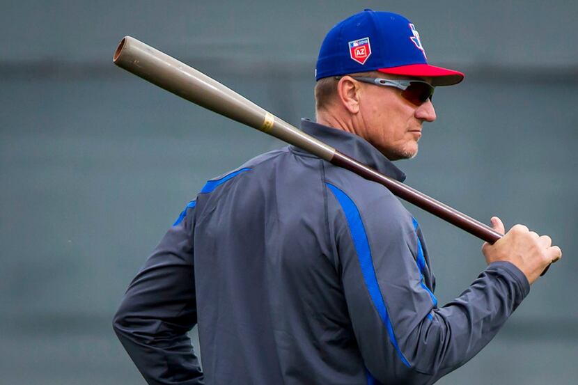 Texas Rangers manager Jeff Banister watches his team workout during a spring training...