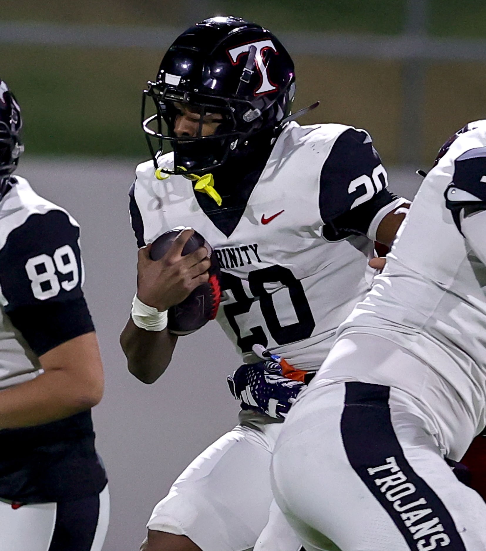 Trinity running back Josh Bell (20) finds a small hole to run against Justin Northwest...