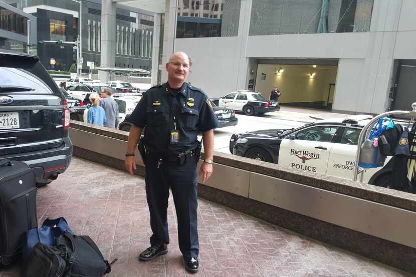 \Fort Worth police Asst. Chief Ken Dean stands in front of a downtown hotel in Houston,...