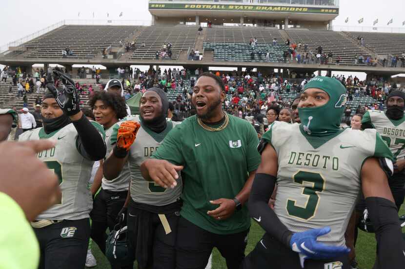DeSoto players and coaches celebrate their 49-35 victory over Duncanville. The two teams...