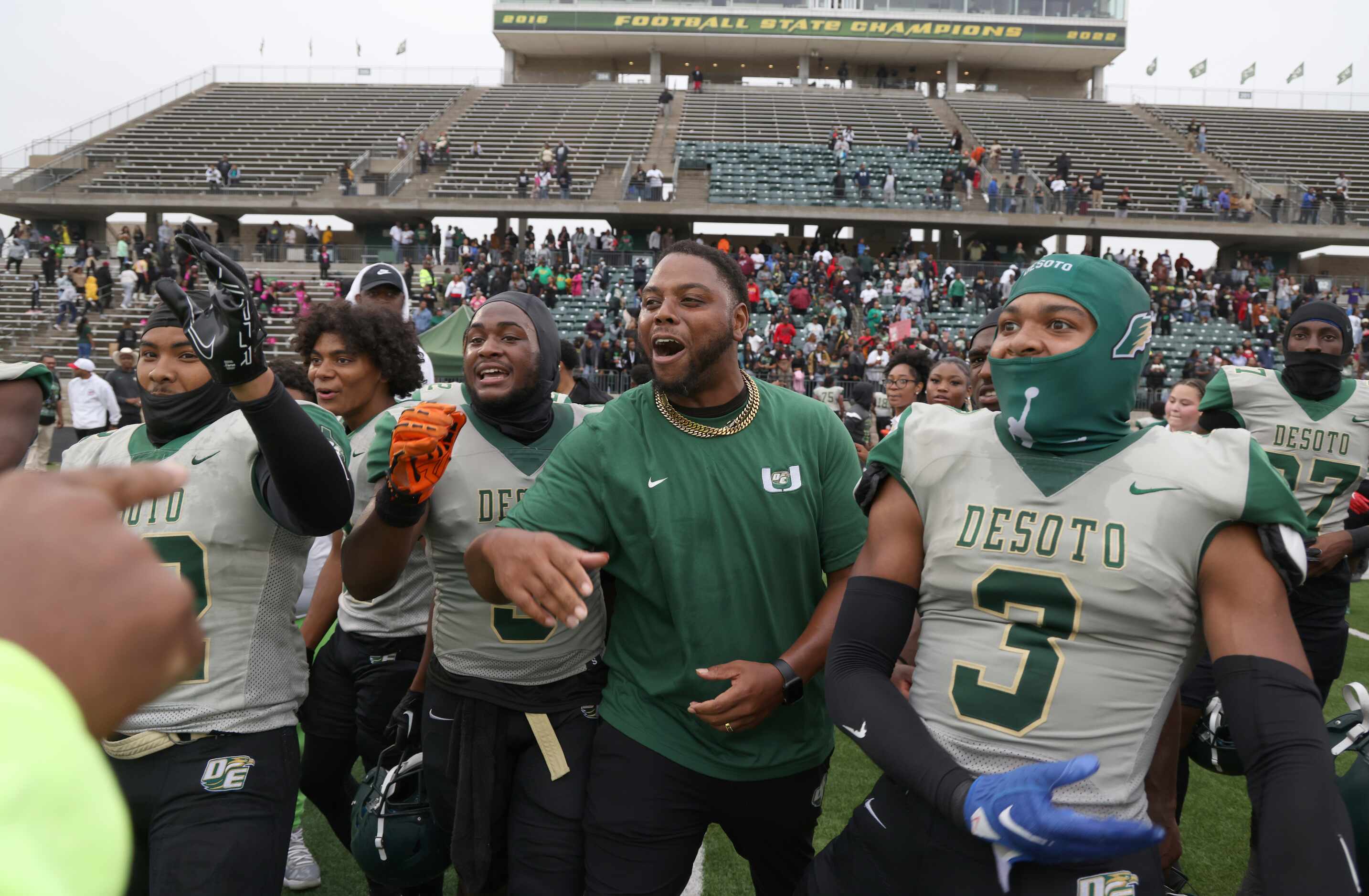 DeSoto players and coaches celebrate their 49-35 victory over Duncanville. The two teams...