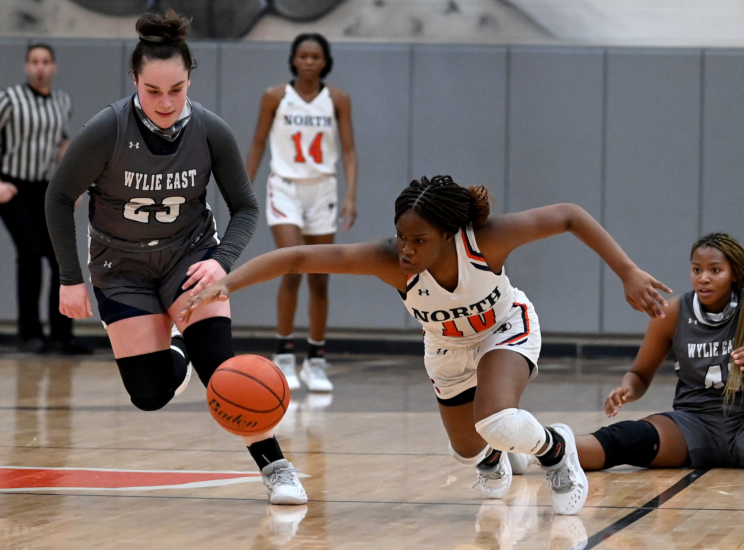 McKinney North’s Kaelyn Hamilton (10) goes after a loose ball with Wylie East’s Kiley Hicks...