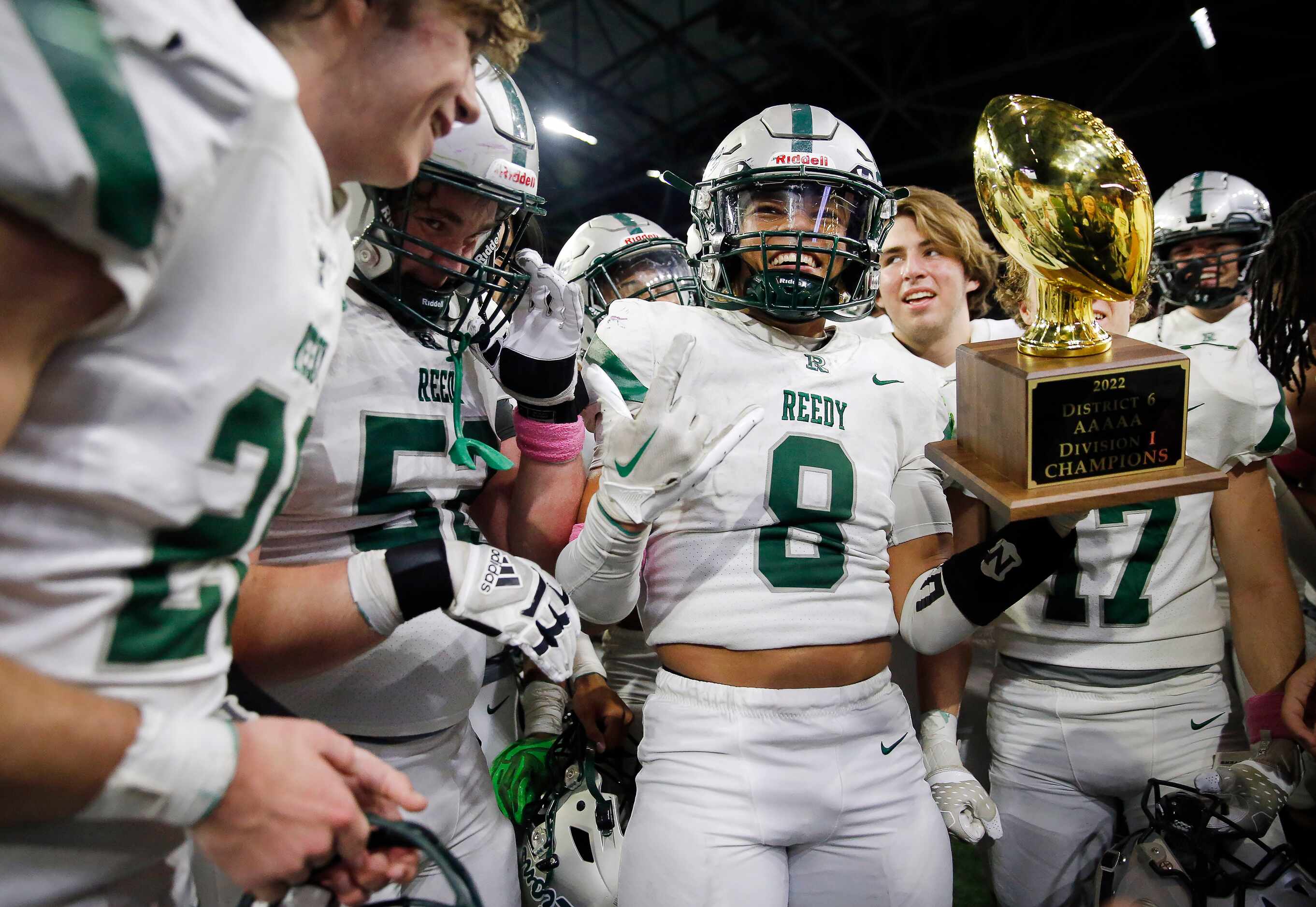 Frisco Reedy linebacker Josef Fuksa (8) celebrates with the District 6-5A trophy following...