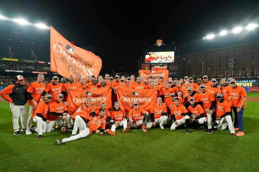 Baltimore Orioles players pose for photographers after defeating the Boston Red Sox 2-0 in a...