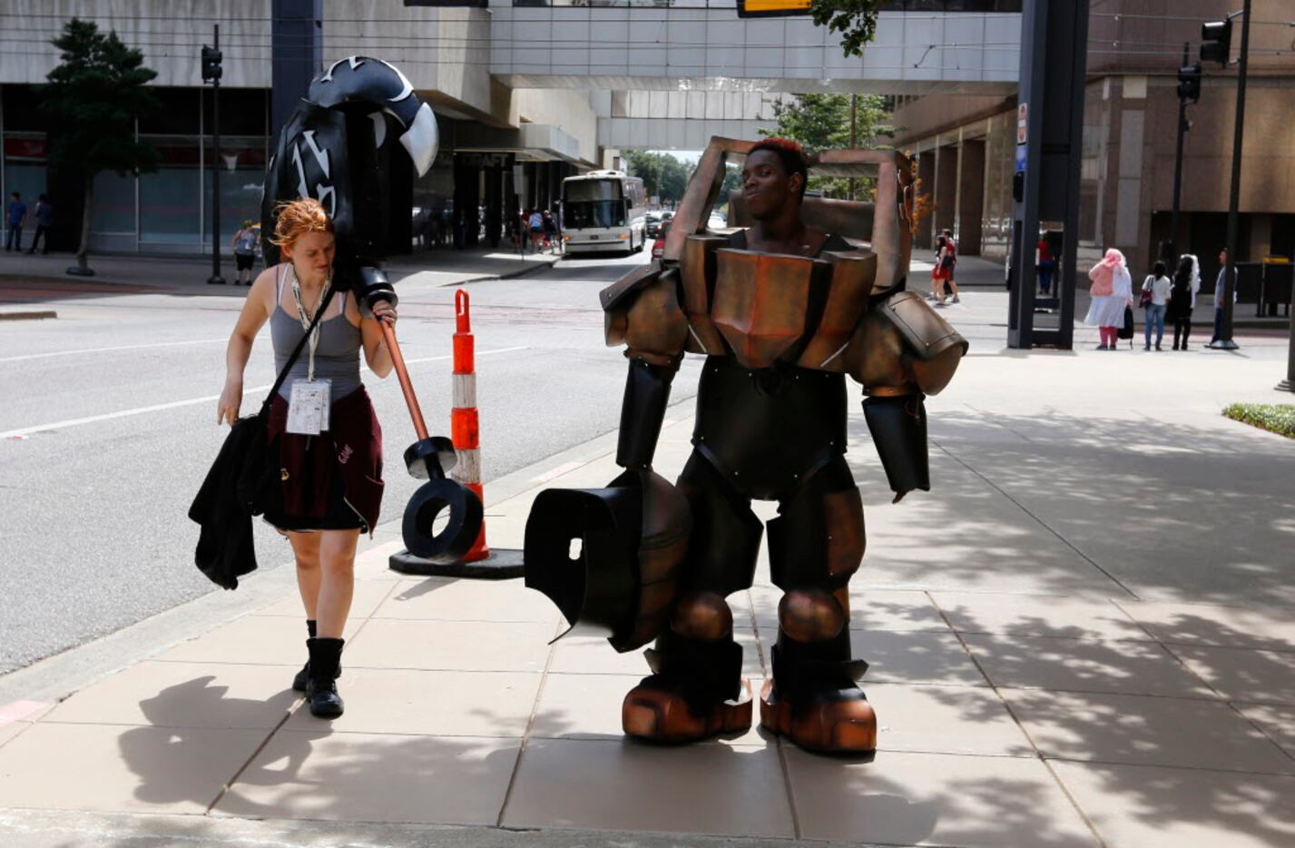 Valerie Nystrom, left, helps Hioshi Jackson, in costume as Nautilus from League of Legends...