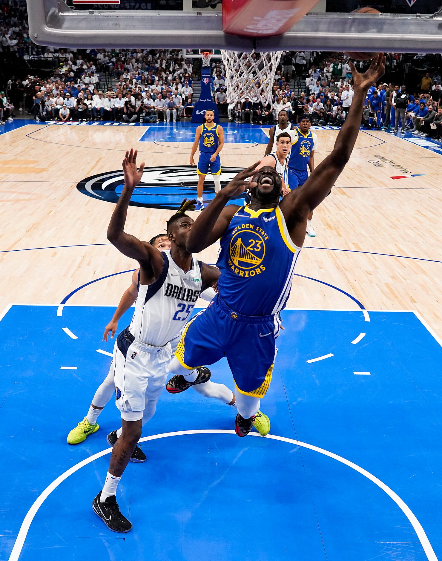 Golden State Warriors forward Draymond Green (23) scores past Dallas Mavericks forward...