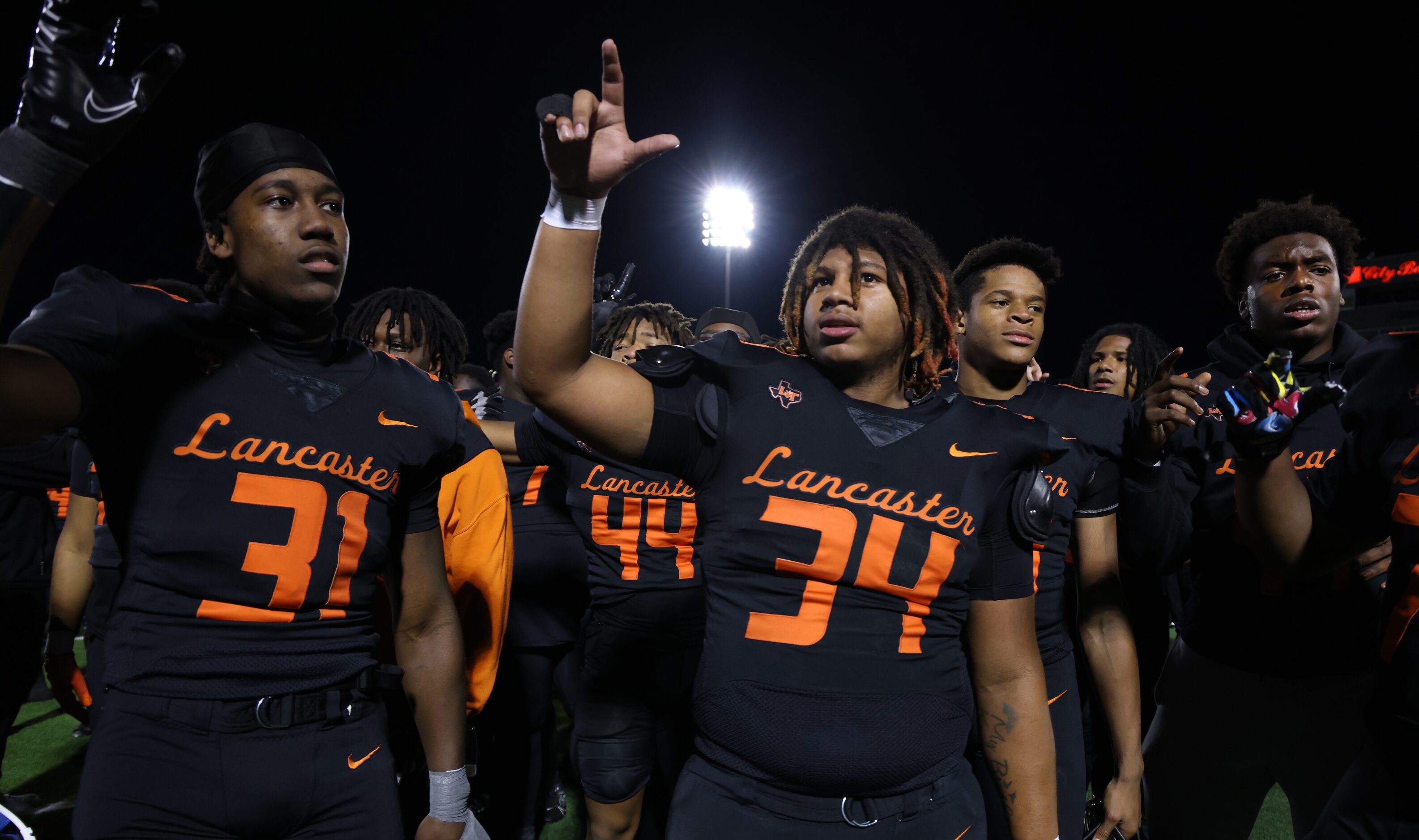 Lancaster players pause for the playing of their school song after their 27-24...