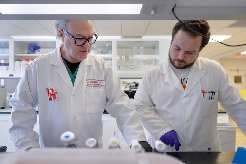 Dr. Colin Haile, left, a research associate professor at the University of Houston, talks...