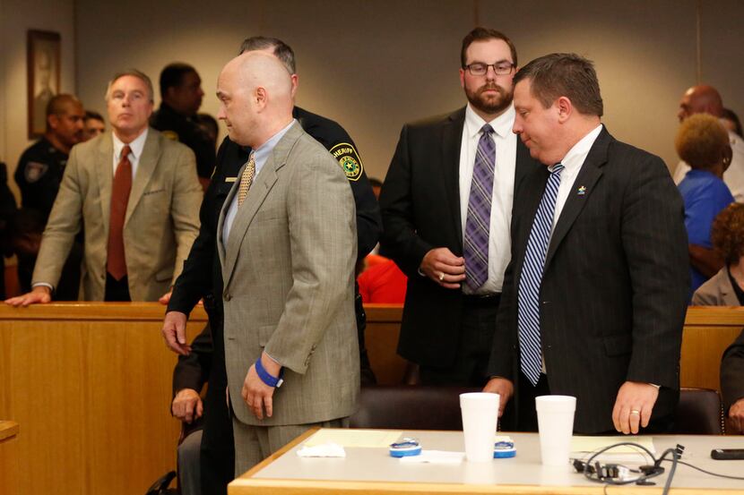 A sheriff's deputy leads Roy Oliver out of the courtroom Wednesday after he was sentenced to...