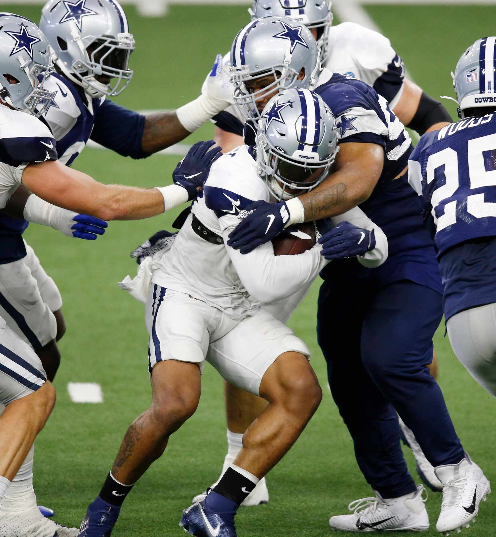 Dallas Cowboys defensive tackle Antwaun Woods (99) wraps up Dallas Cowboys running back Tony...