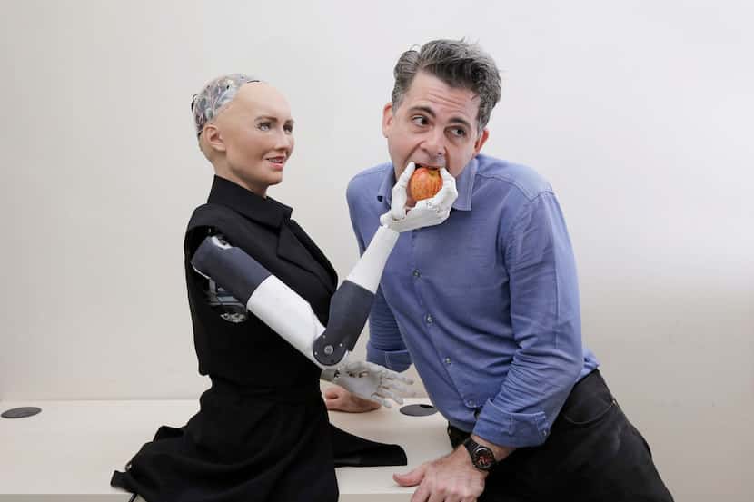 David Hanson, founder of Hanson Robotics, poses with his company's flagship robot Sophia.
