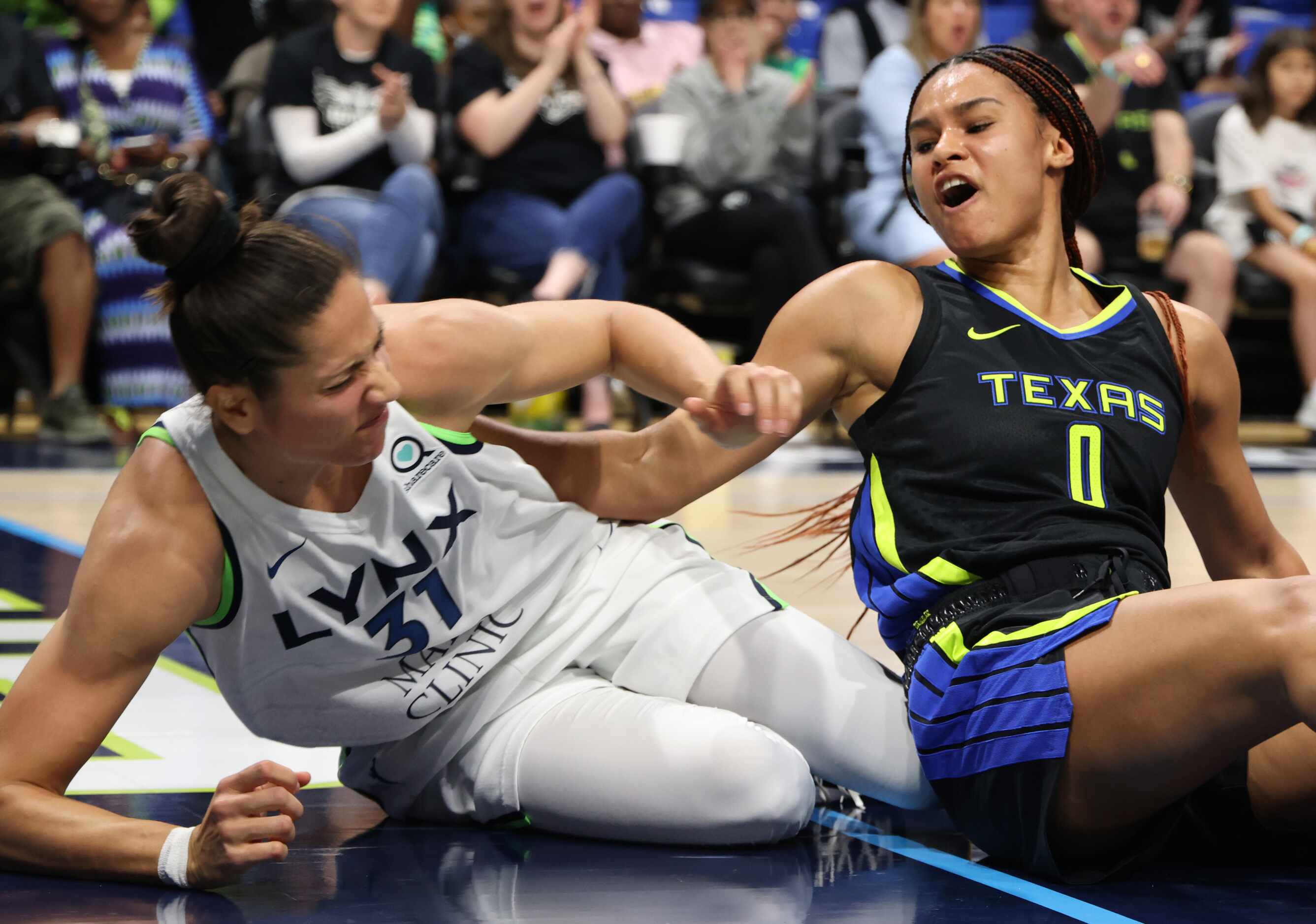 Dallas Wings forward Satou Sabally(0) reacts after battling for a rebound against Minnesota...