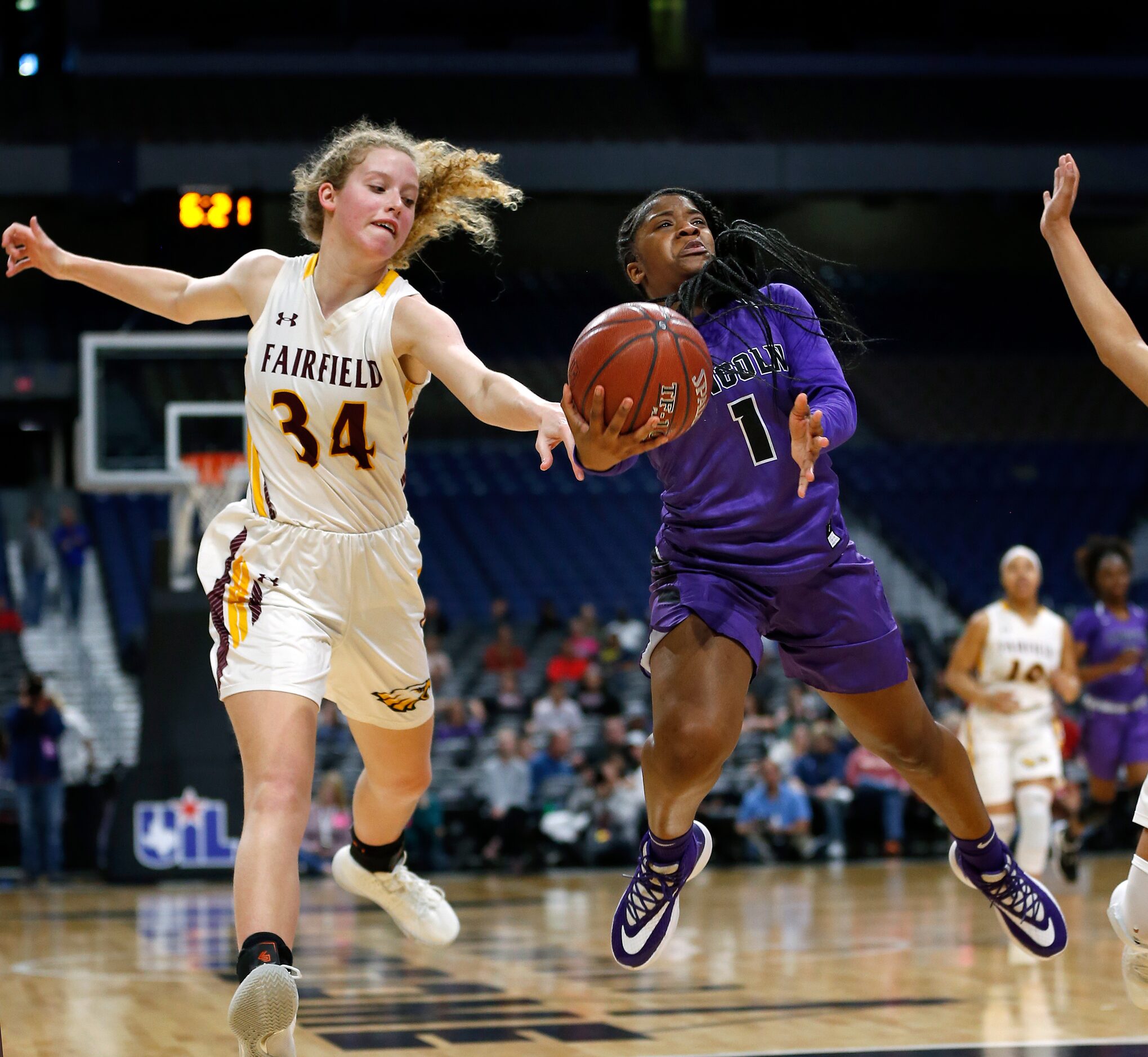 Lincoln guard Alexis Brown (#1) drives on Fairfield center Braden Bossier (#34) in a 4A...