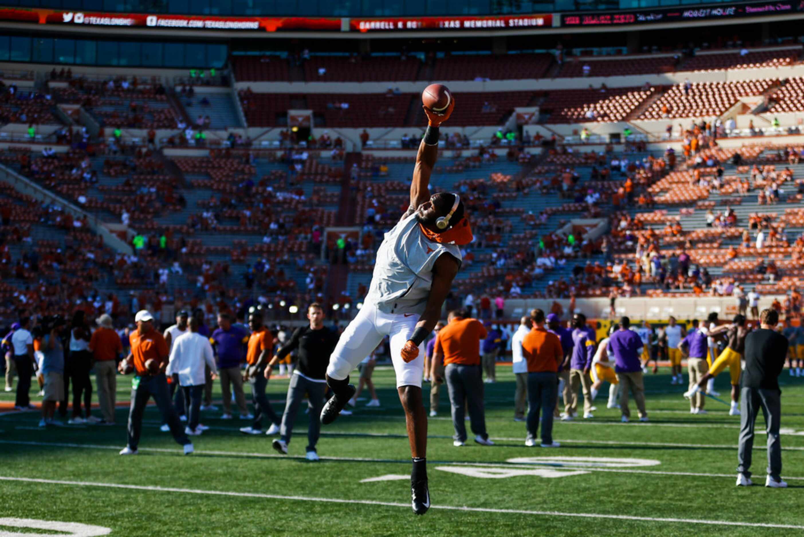 Texas Longhorns players warm up prior to a college football game between the University of...