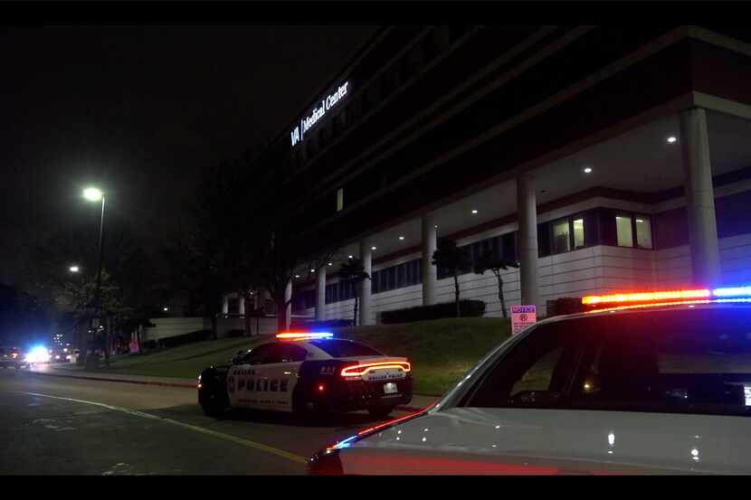 Dallas police squad cars park outside the Dallas Veterans Affairs Medical Center near where...