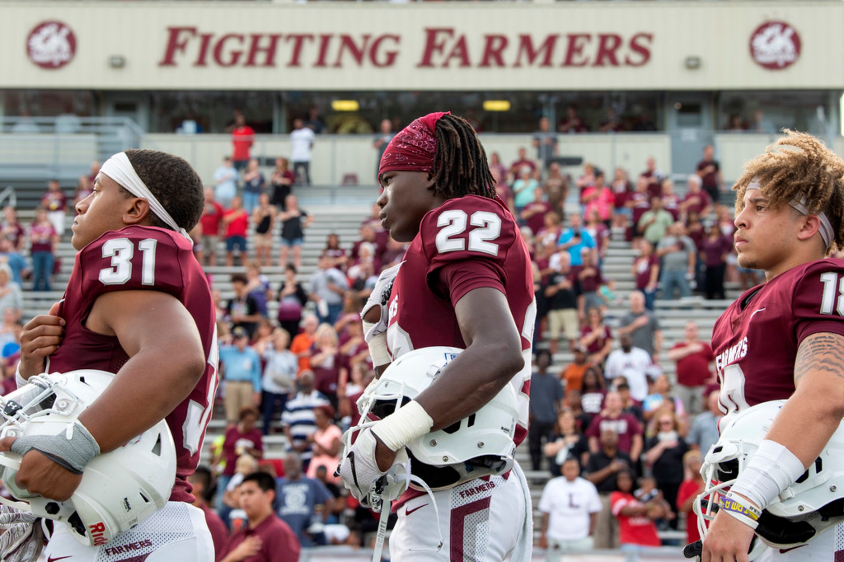 Lewisville senior Richard Holmes (22), junior Carl Levy III (31), and senior Miguel...